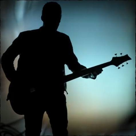 silhouette of a musician playing an F Bass instrument